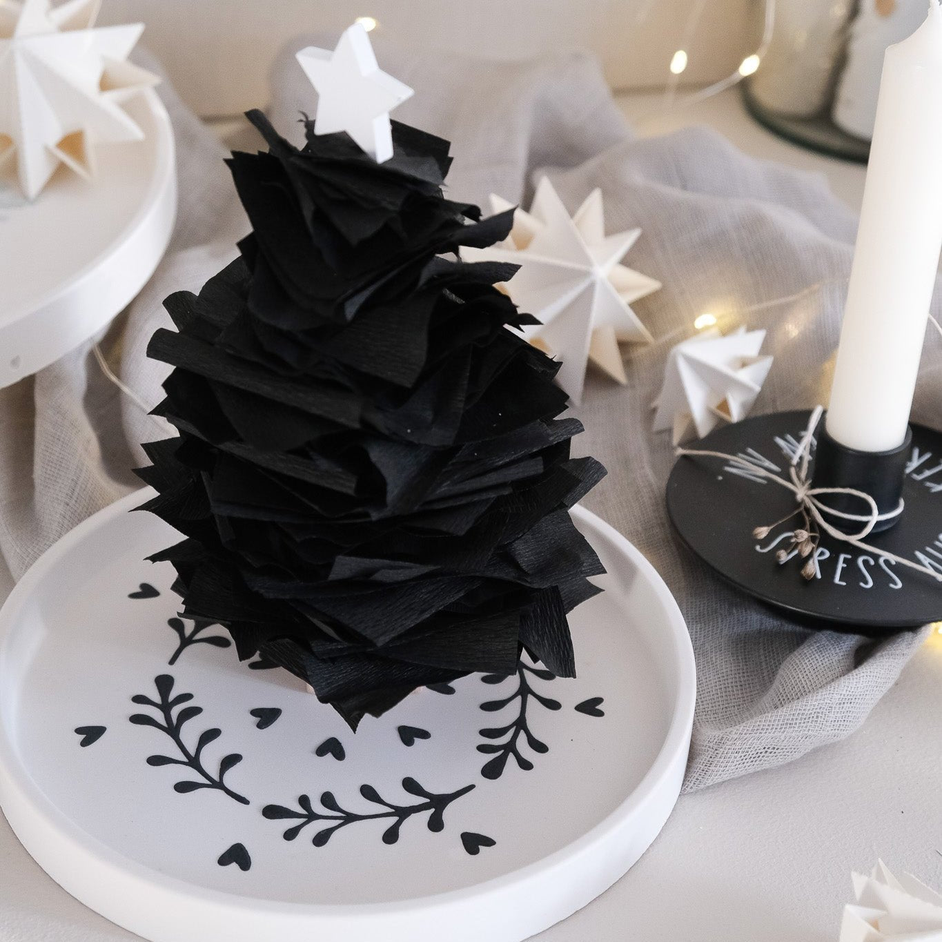 Bastelidee mit einem gegossenen Teller der mit der schwarzen Strukturpaste verziert wurde. Tannenbaum aus Krepppapier steht auf dem Teller.