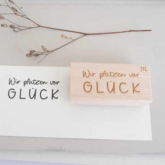 Holzstempel 3 x 6 cm mit Text "Wir platzen vor Glück".